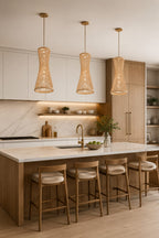 Modern kitchen with woven bamboo pendant lights, island, and bar stools.