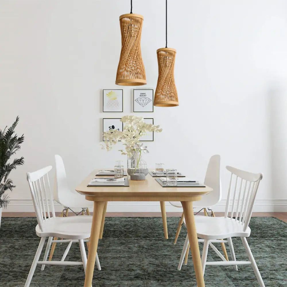 Dining room with  table and white chairs, featuring woven bamboo pendant lights.